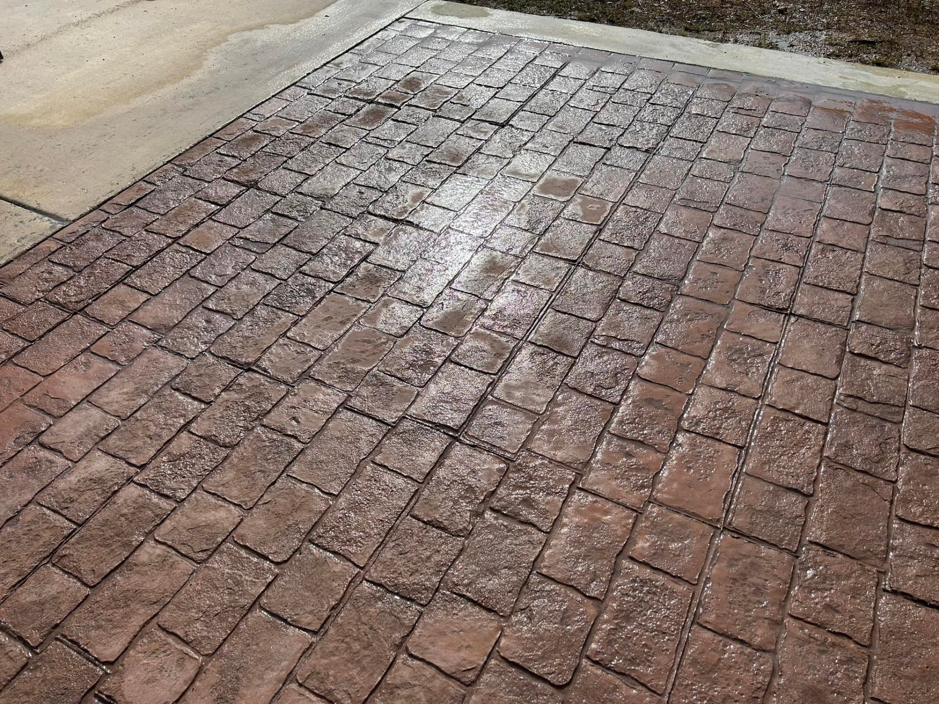 Stamped cobblestone-pattern concrete driveway