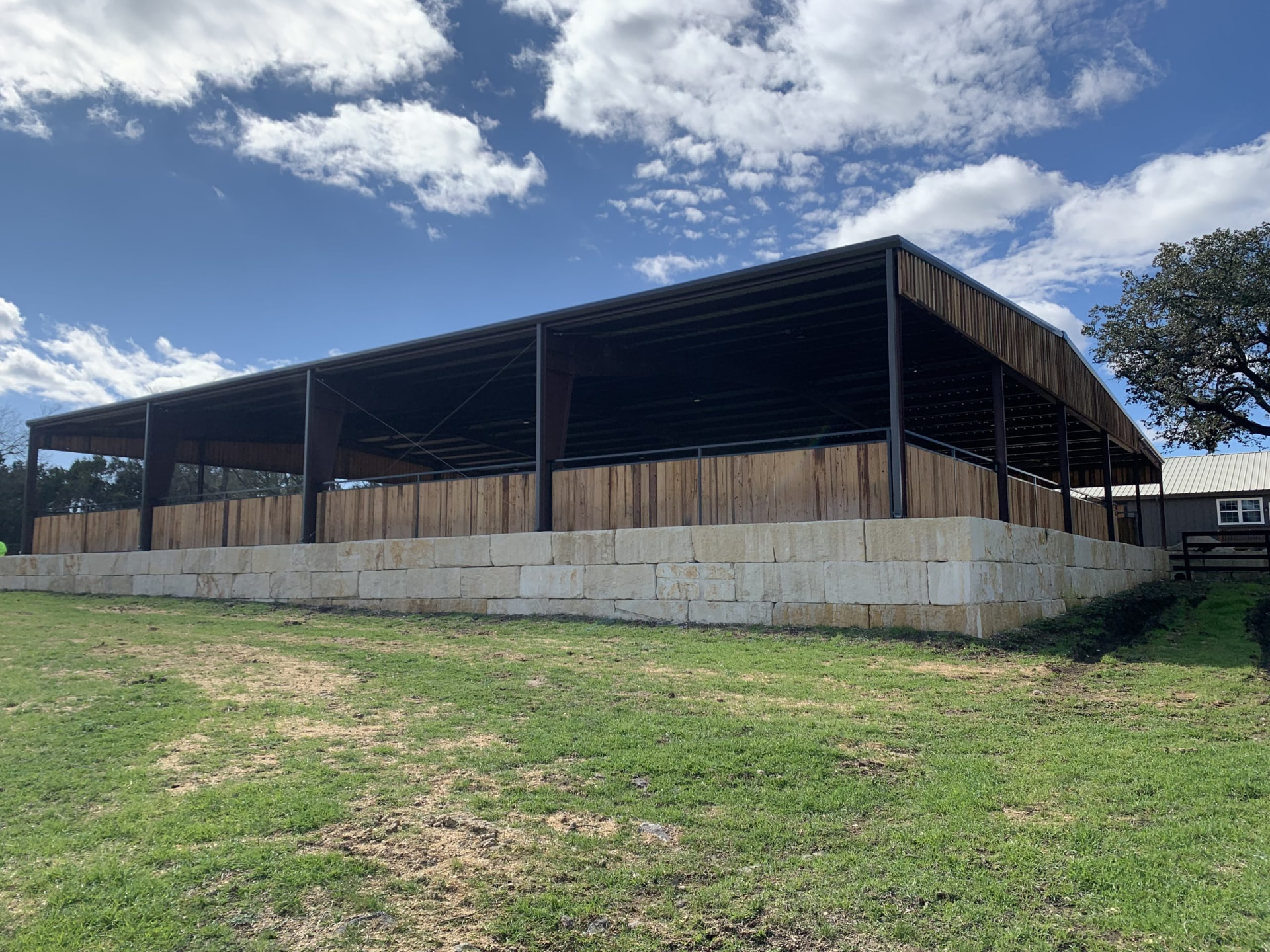 Steel pavilion on a cut limestone block retaining wall