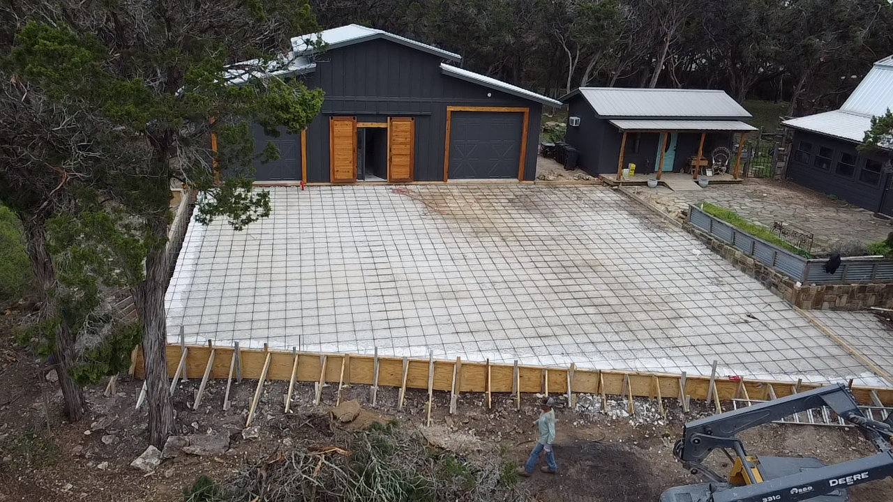 Formed and reinforced concrete driveway slab ready for pour at a Hill Country home