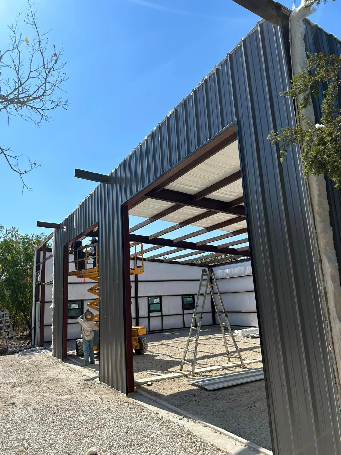 Metal building framing going up over a concrete slab